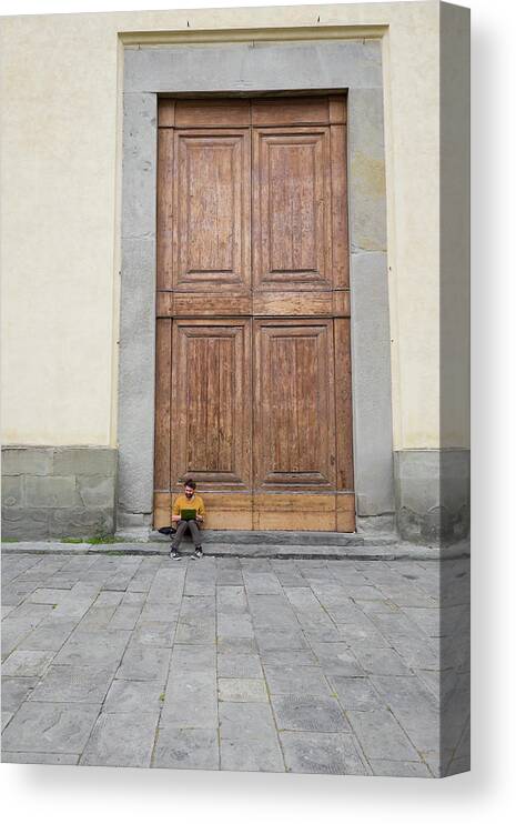 Man Canvas Print featuring the photograph Man sitting on the stoop of the large wooden doors by David L Moore