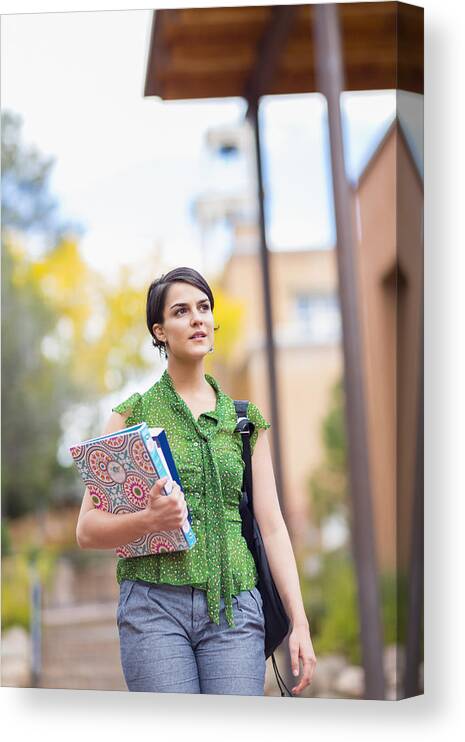 Three Quarter Length Canvas Print featuring the photograph Mixed race student carrying books on campus by Marc Romanelli
