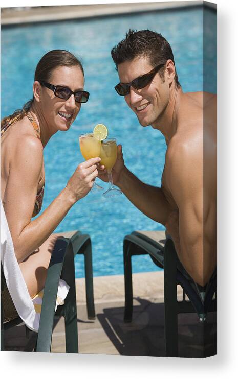 Mid Adult Women Canvas Print featuring the photograph Poolside couple with cocktails by Comstock Images