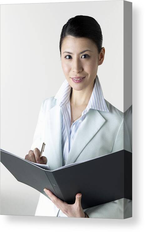 White Background Canvas Print featuring the photograph Portrait of a Businesswoman With a Folder in Her Hands by Mash