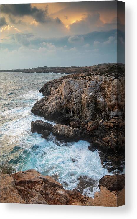 Stormy Sea Canvas Print featuring the photograph Seascape with windy waves during stormy weather at sunset. by Michalakis Ppalis