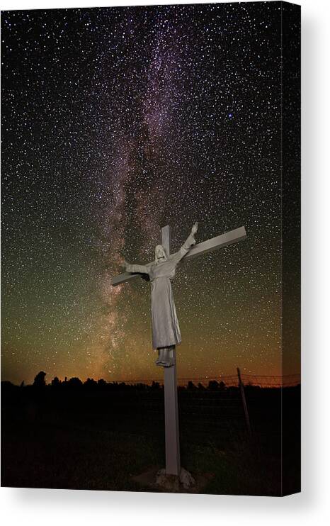 Milky Way Canvas Print featuring the photograph The Heavens Declare - Jesus with raised arms on cross in front of Milky Way by Peter Herman