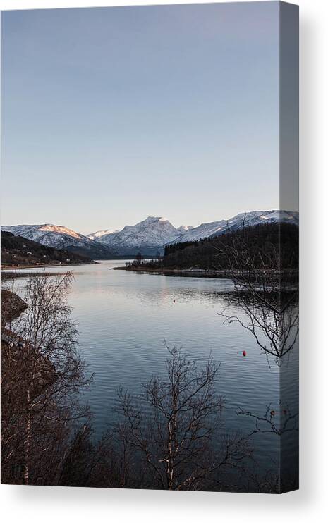 Christmas Canvas Print featuring the photograph The snowy hills are illuminated by the last vestige of orange sunlight. Narvik, Norway by Vaclav Sonnek