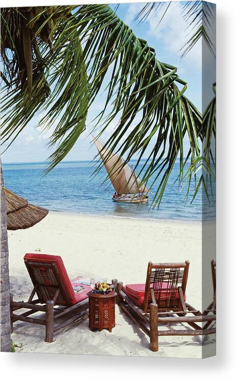 Traveloutdoorsbeachseasandpalm Tree Tropicalislandrelaxationboatfishingsummerskyoceanvacationsailboat Canvas Print featuring the photograph View of a Secluded Beach in Mozambique by Tim Beddow