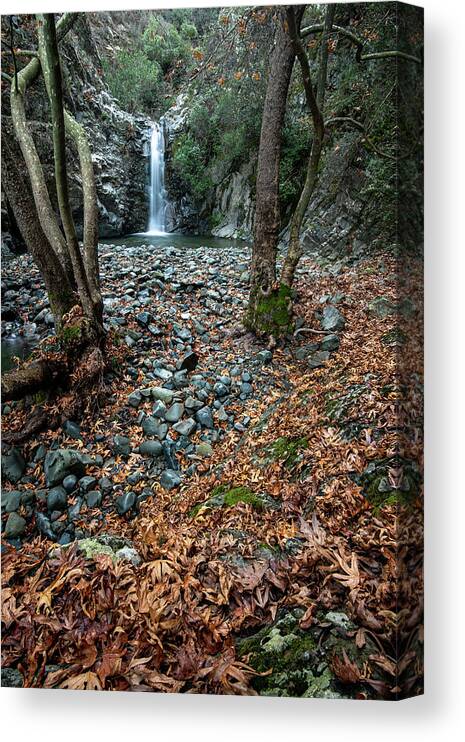 Autumn Landscape Canvas Print featuring the photograph Waterfall splashing in the canyon in autumn. by Michalakis Ppalis