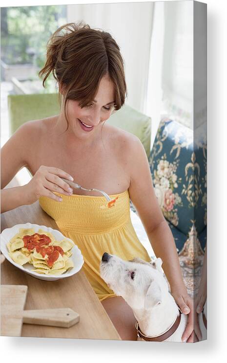 Pets Canvas Print featuring the photograph Woman teasing her dog with pasta by Cultura RM Exclusive/Christine Schneider