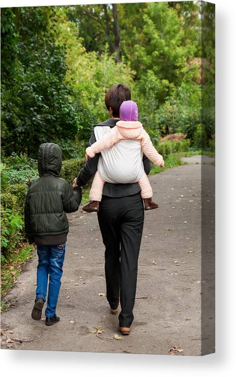 Vertical Canvas Print featuring the photograph Woman with two siblings in park by I_rinka