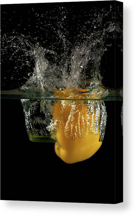 Pepper Canvas Print featuring the photograph Yellow bell pepper dropped and slashing on water by Michalakis Ppalis