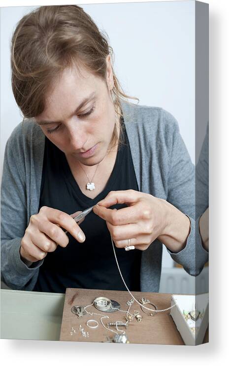 People Canvas Print featuring the photograph Young woman makes a necklace by Reza Estakhrian