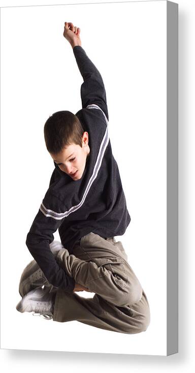 White Background Canvas Print featuring the photograph Silhouette Of A Caucasian Teenage Boy In Tan Pants And A Blue Shirt As He Jumps Up And Grabs His Feet by Photodisc