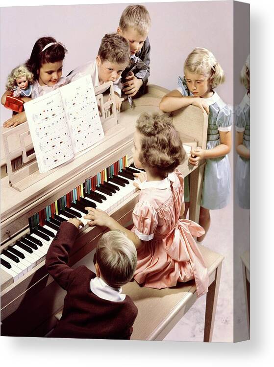 Children Canvas Print featuring the photograph A Group Of Children At The Piano by Herbert Matter