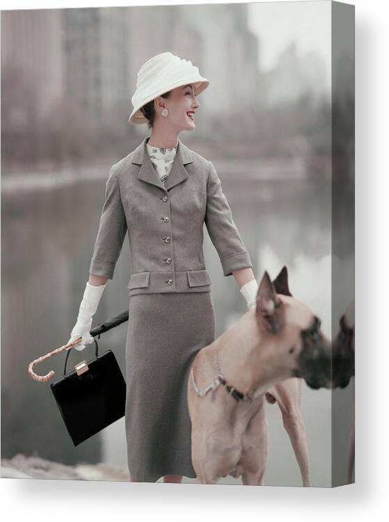 Fashion Canvas Print featuring the photograph A Model Wearing A Gray Suit With A Dog by Karen Radkai