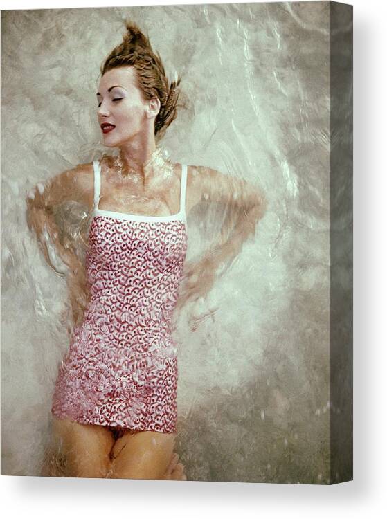 Fashion Canvas Print featuring the photograph A Model Wearing A Swimsuit by Leombruno-Bodi