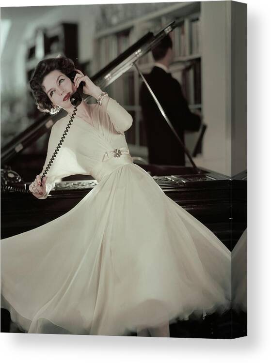 Fashion Canvas Print featuring the photograph A Model Wearing An Evening Gown Leaning by Karen Radkai