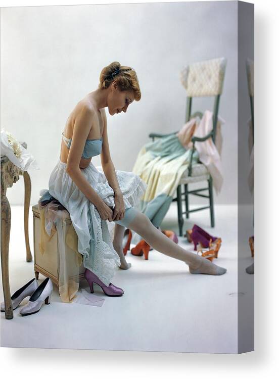 Accessories Canvas Print featuring the photograph A Woman Putting On Her Stockings by John Rawlings