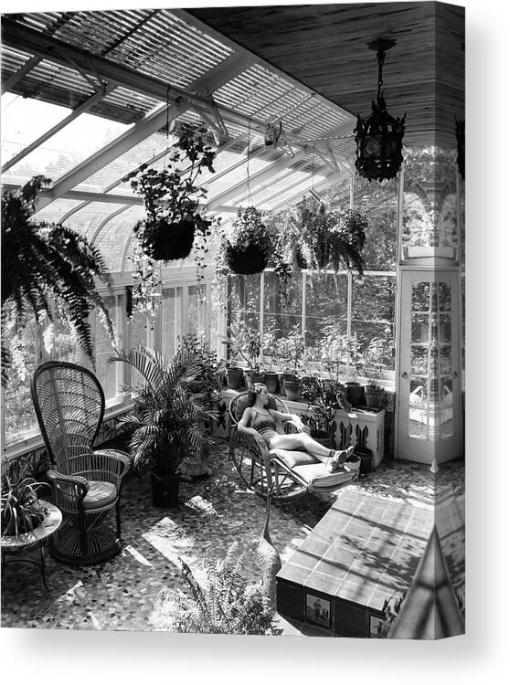 Architecture Canvas Print featuring the photograph A Woman Resting On A Chair Inside A Greenhouse by Eric J. Baker