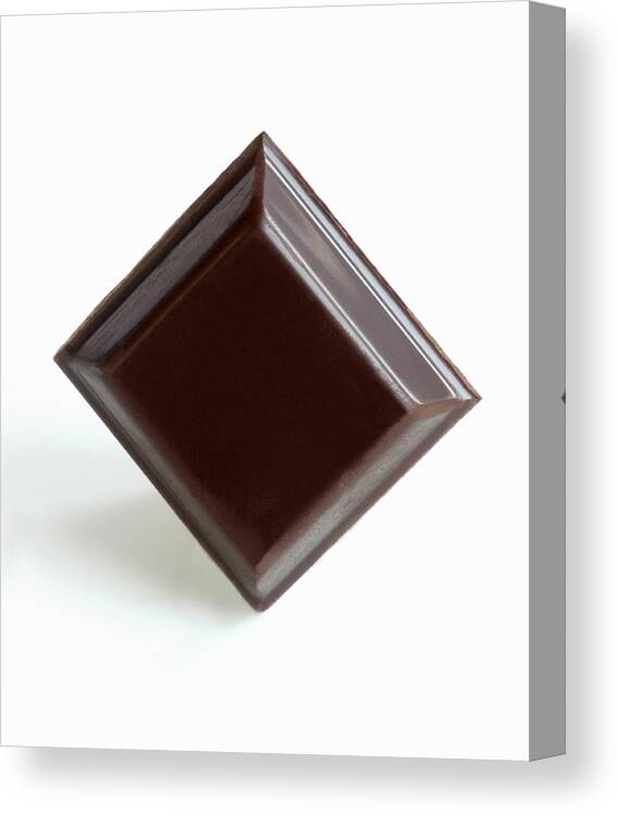 Unhealthy Eating Canvas Print featuring the photograph Square of dark chocolate. by Rosemary Calvert