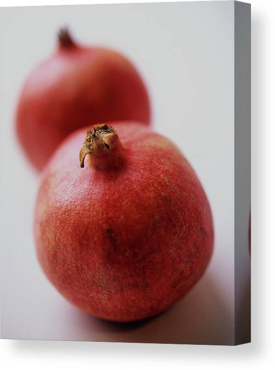 Fruits Canvas Print featuring the photograph Two Pomegranates by Romulo Yanes