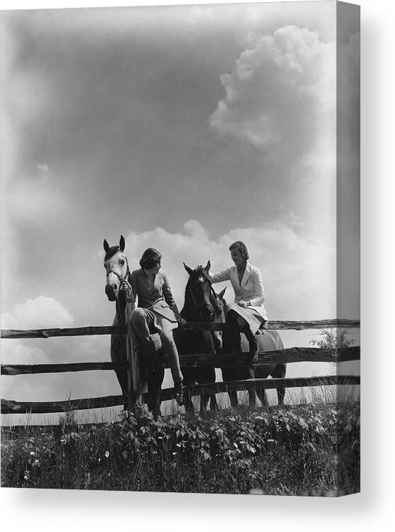 Animal Canvas Print featuring the photograph Two Women Sitting On A Fence With Horses by Lusha Nelson