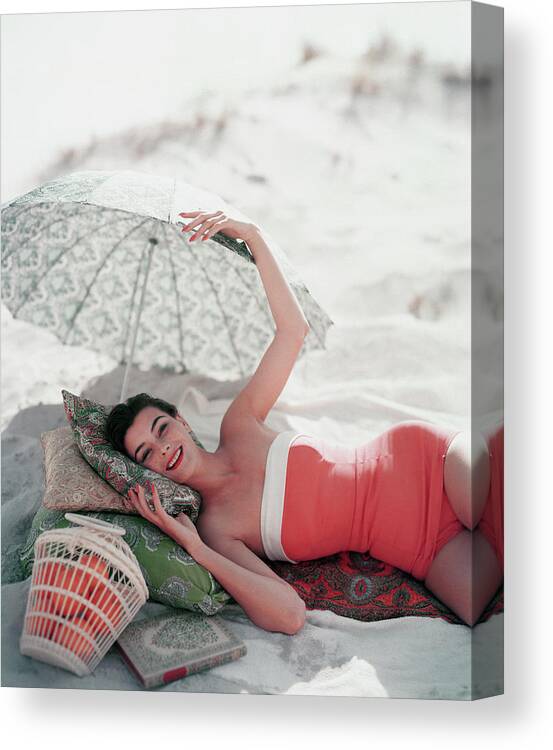 Model Ann Gunning Under Beach Umbrella Canvas Print featuring the photograph Vogue July 1st, 1954 by Karen Radkai
