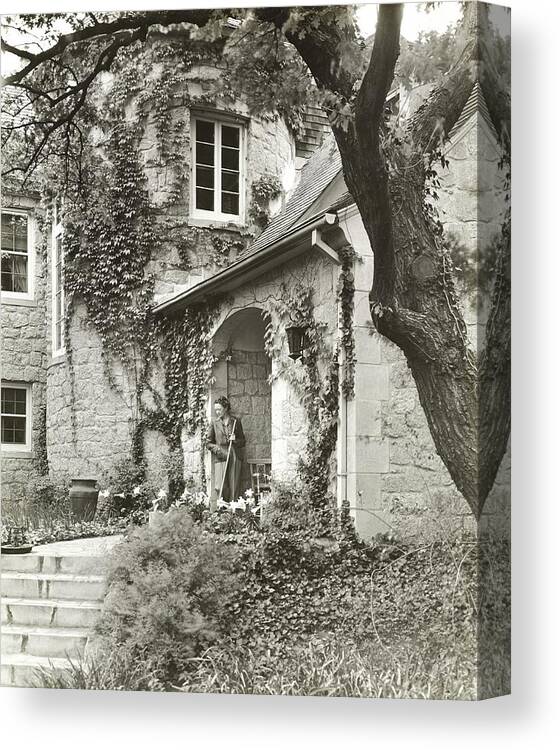 Exterior Canvas Print featuring the photograph Woman In Doorway Of House by Peter Nyholm