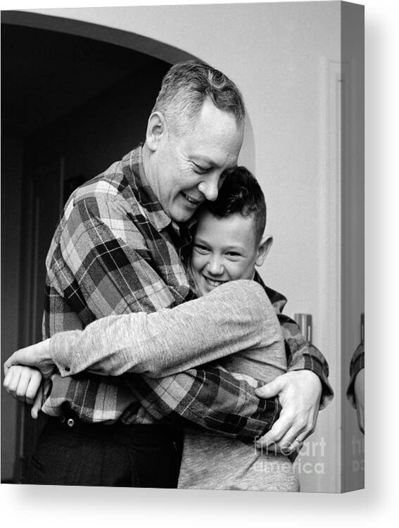 1950s Canvas Print featuring the photograph Father And Son Embracing, C.1950-60s by H. Armstrong Roberts/ClassicStock