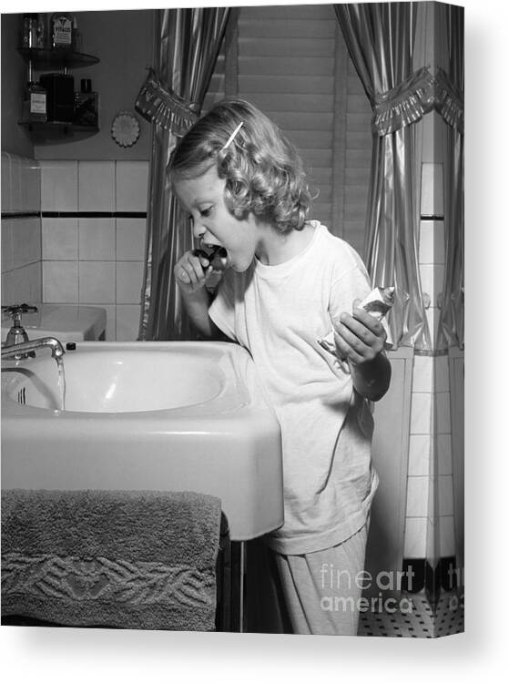 1950s Canvas Print featuring the photograph Girl Brushing Her Teeth, C.1950s by E. Hibbs/ClassicStock