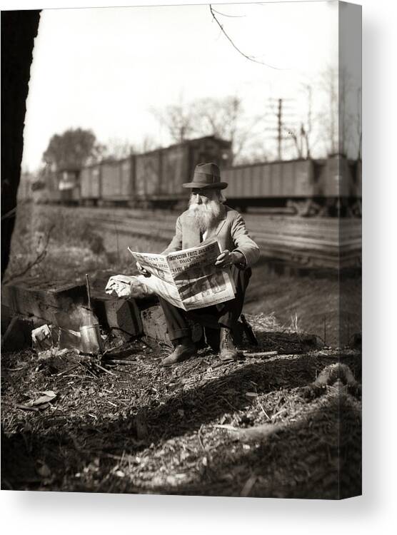 Photography Canvas Print featuring the photograph 1930s Hobo Sitting By Railroad Track by Vintage Images