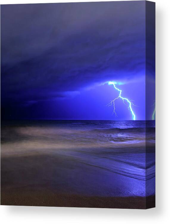 Water's Edge Canvas Print featuring the photograph A Bolt Of Lightning From An Approaching by Stocktrek Images/luis Argerich