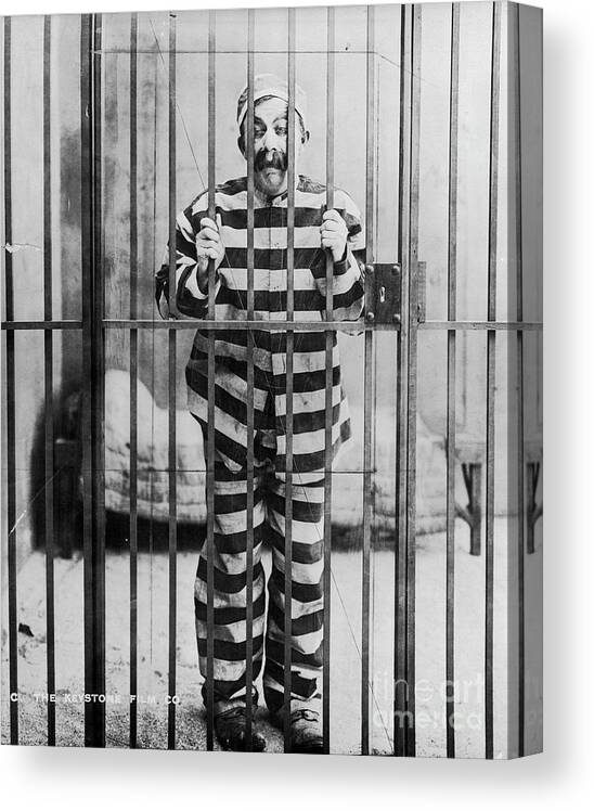 People Canvas Print featuring the photograph Chester Conklin Behind Bars In Dodging by Bettmann
