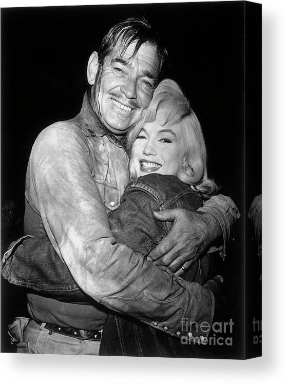 Mature Adult Canvas Print featuring the photograph Clark Gable Embracing Marilyn Monroe by Bettmann