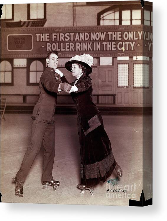 Mid Adult Women Canvas Print featuring the photograph Couple Skating In Roller Rink by Bettmann