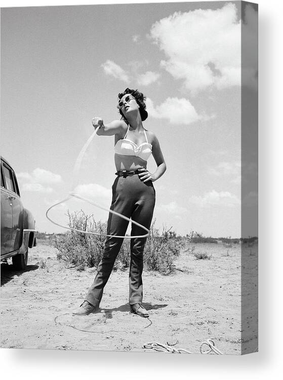 1955 Canvas Print featuring the photograph Elizabeth Taylor Spinning Lasso On The Set Of Giant by Frank Worth