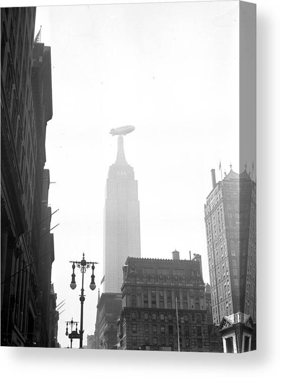 1930-1939 Canvas Print featuring the photograph Goodyear Blimp Flies Near The Empire by New York Daily News Archive