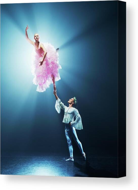 Young Men Canvas Print featuring the photograph Male Ballet Dancer Holding Up Female by Henrik Sorensen