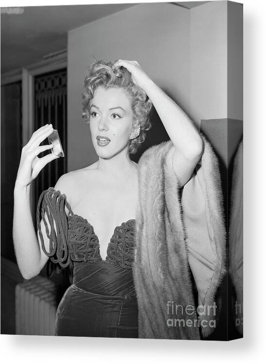 People Canvas Print featuring the photograph Marilyn Monroe Checking Her Appearance by Bettmann