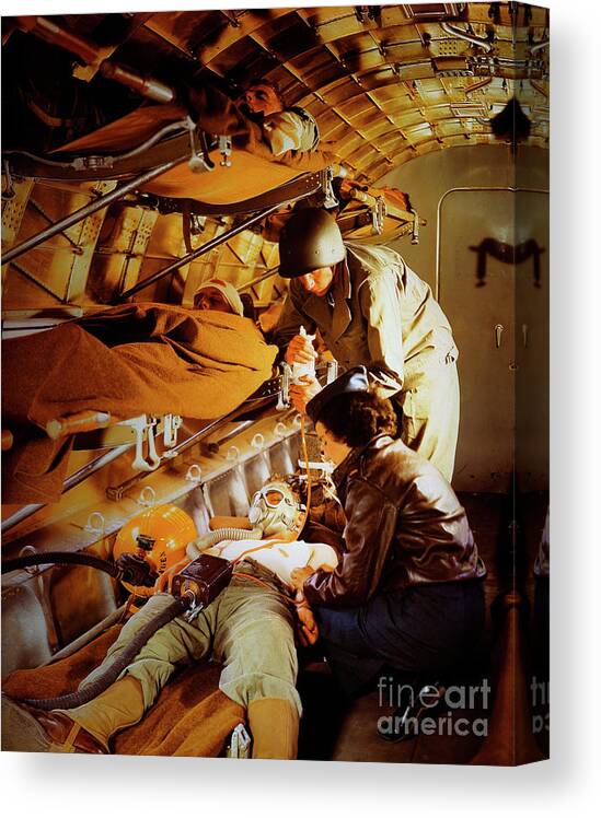 Working Canvas Print featuring the photograph Military Nurse Helping The Wounded by Bettmann