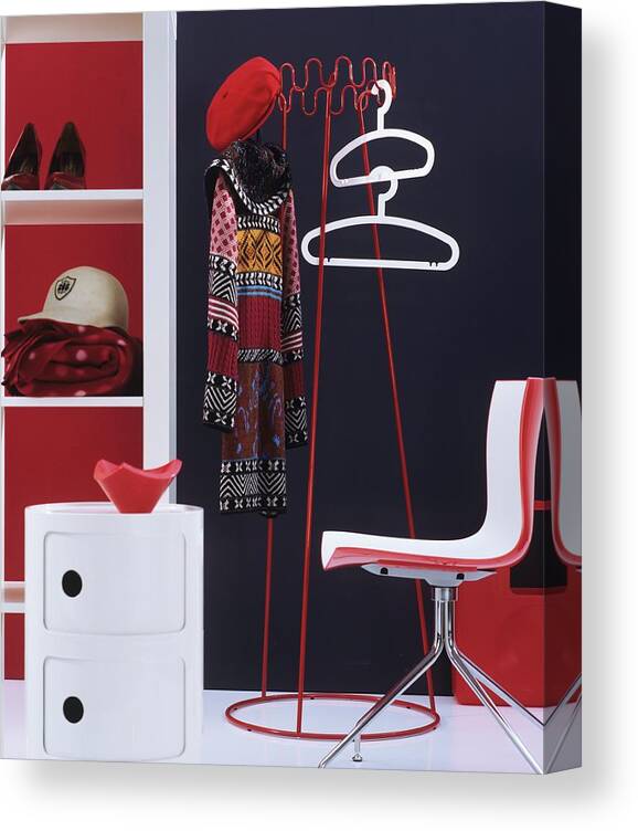 Ip_11407828 Canvas Print featuring the photograph Retro Cloakroom Furniture In Red And White With Coat Hangers And Coat Rack Against Dark Wall by Matteo Manduzio