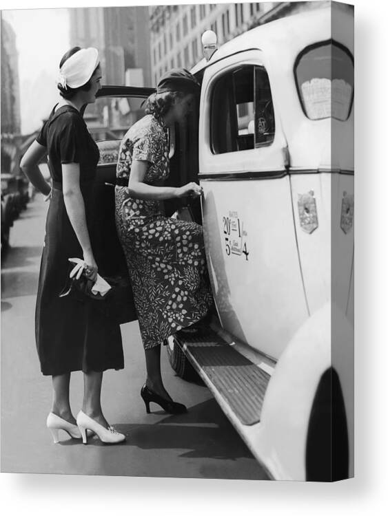 People Canvas Print featuring the photograph Two Women Getting In A Taxi On An Urban by Fpg