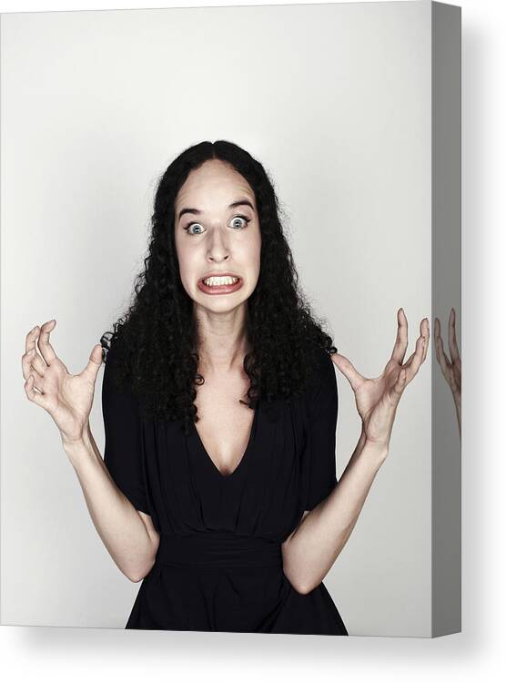People Canvas Print featuring the photograph Portrait of woman looking frustrated #1 by Flashpop