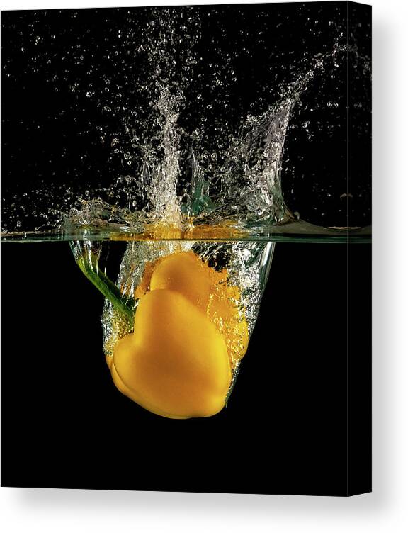 Pepper Canvas Print featuring the photograph Yellow bell pepper dropped and slashing on water by Michalakis Ppalis