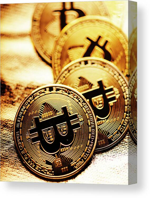 Bitcoin Canvas Print featuring the photograph Closeup of golden bitcoin over gold background by Jelena Jovanovic