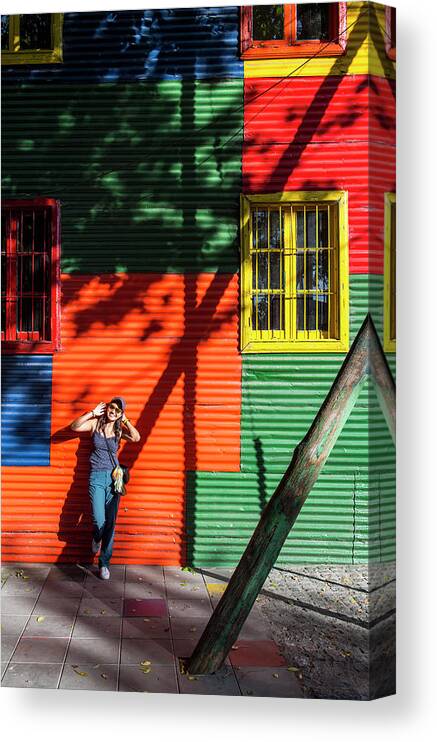 Buenos Aires Canvas Print featuring the photograph Woman Exploring The La Boca District In Buenos Aires by Cavan Images