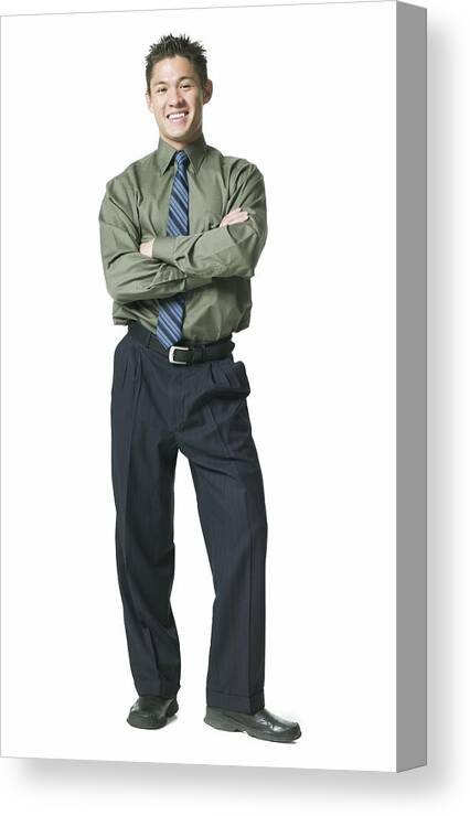 White Background Canvas Print featuring the photograph Full Body Shot Of A Young Adult Business Man In A Green Shirt As He Folds His Arms And Smiles by Photodisc