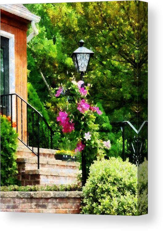 Lamp Post Canvas Print featuring the photograph Clematis on a Lamp Post by Susan Savad