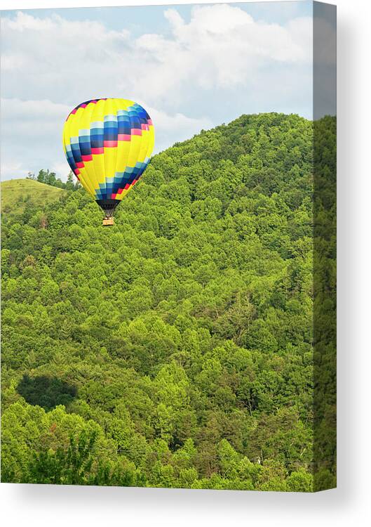 Recreational Pursuit Canvas Print featuring the photograph Hot Air Balloon In A Blue Sky by Wbritten