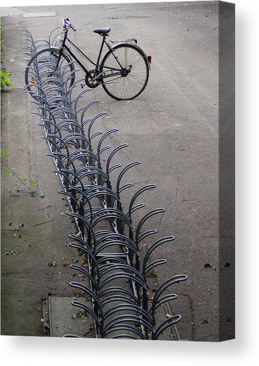 Bicycle Canvas Print featuring the photograph Lonely bike at bicycle rack by Matthias Hauser