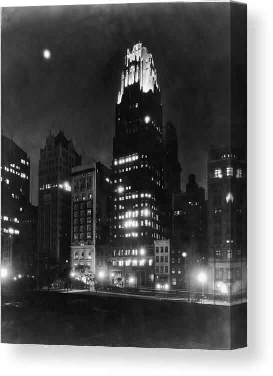 Black Color Canvas Print featuring the photograph American Radiator Building At Night by Fpg