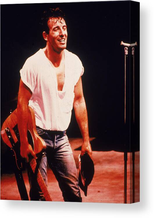 Rock Music Canvas Print featuring the photograph Bruce Springsteen Holds Guitar On Stage by Hulton Archive