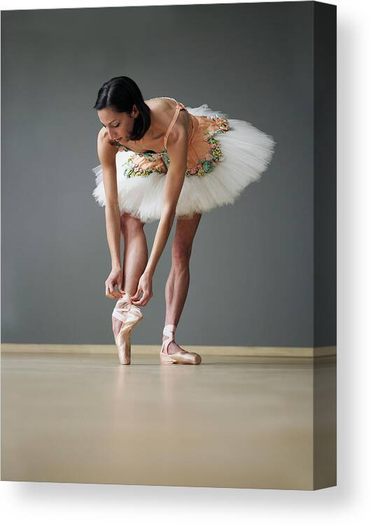 Ballet Dancer Canvas Print featuring the photograph Young Female Ballerina Adjusting Ballet by Thomas Barwick